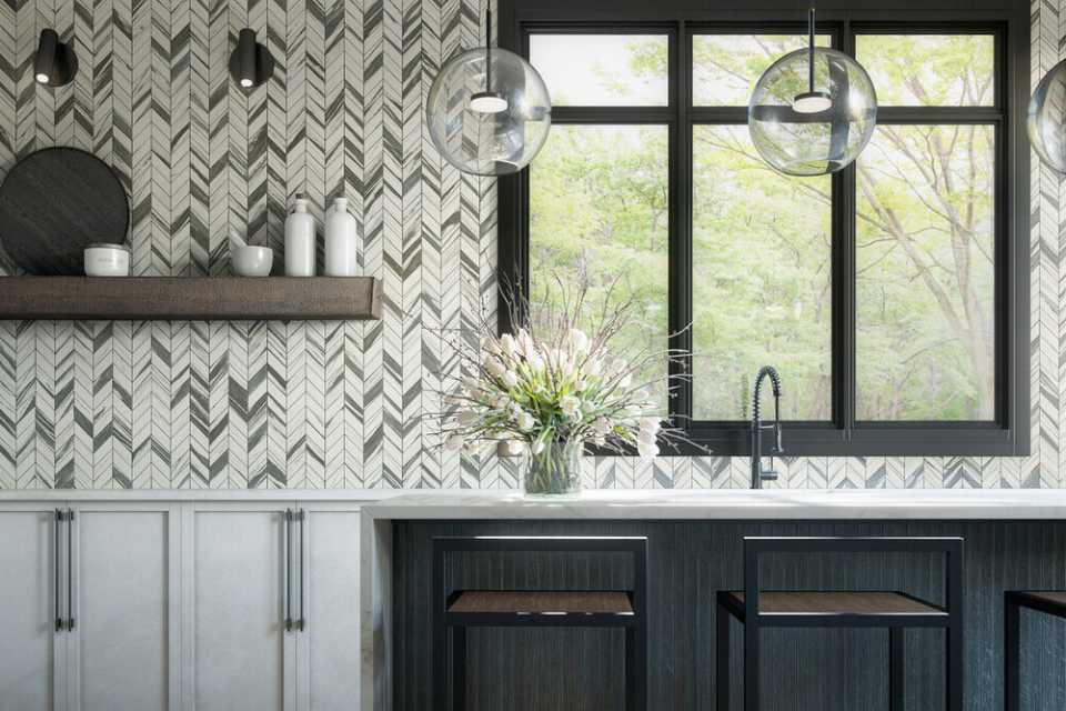 black and white mosaic chevron pattern backsplash in modern kitchen with glass pendant lights